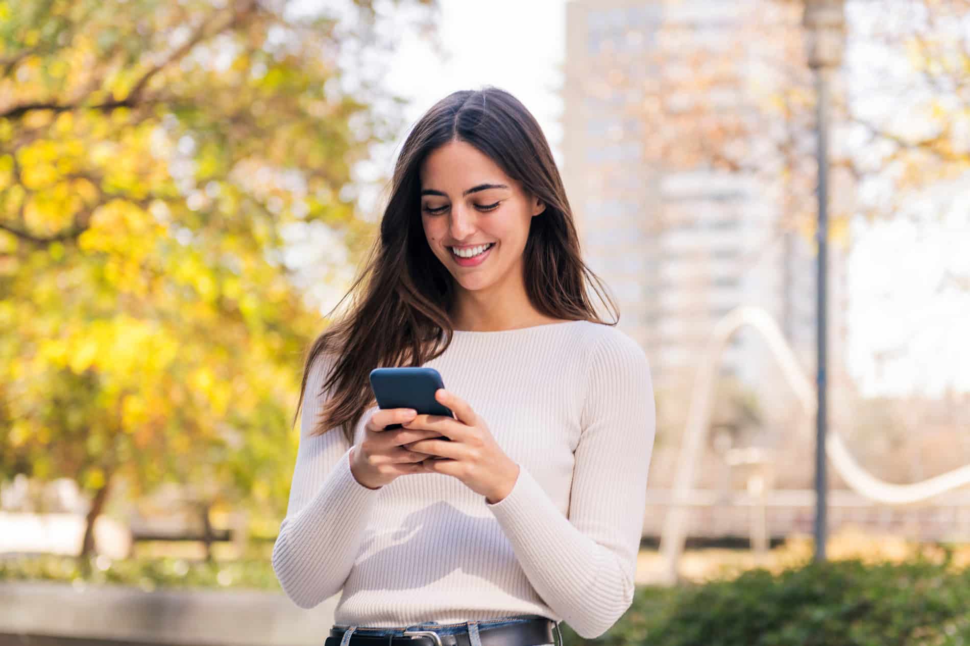 Woman looking at her dental monitoring app in South Jordan UT